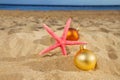 Christmas balls with starfush on beach Royalty Free Stock Photo