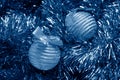 christmas balls on tinsel toned in trendy Classic Blue color of the Year 2020 Royalty Free Stock Photo