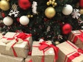 Christmas balls under the Christmas tree with boxes of New Year is gifts winter holidays background