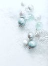 Christmas balls on a white stone background with snow Royalty Free Stock Photo