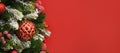 Christmas banner with balls and fir branches on red background. Xmas greeting card. Royalty Free Stock Photo