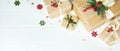 Christmas banner with border of gift boxes on white wood background