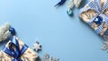 Christmas banner with gift boxes, fir branches, blue and silver decorations on blue background Royalty Free Stock Photo