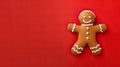 Christmas banner, gingerbread man on red background with copy space at Christmastime. Tradition of Happy Christmas. Joyful