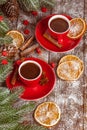 Christmas banner with green tree, cones, red cups with hot chocolate, orange and cinnamon on brown wooden background Royalty Free Stock Photo