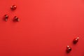Christmas banner mockup with red baubles decoration on red background. Xmas greeting card template. Flat lay, top view Royalty Free Stock Photo