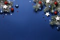 Christmas banner with snow fir branches, shiny red balls, blue and white stars on a classic blue background. New year Royalty Free Stock Photo