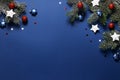 Christmas banner with snow fir branches, shiny red balls, blue and white stars on a classic blue background. New year Royalty Free Stock Photo