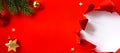 Christmas banner. Christmas tree branch decorated golden color balls and stars on red background. Wide Xmas banner mockup, header