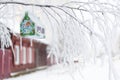Christmas Barn Birdhouse Covered In Snow With Snow Covered Trees Blurred In Background