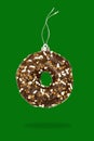 Christmas bauble ball decoration toy made of sweet sugar chocolate brown glazed doughnut donut dessert on dark green