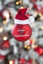 Christmas bauble close up christmas tree in background Royalty Free Stock Photo