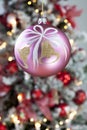 Christmas bauble close up christmas tree in background Royalty Free Stock Photo