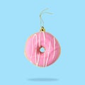 Christmas bauble decoration made of pink doughnut Royalty Free Stock Photo