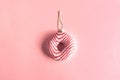 Christmas bauble decoration made of pink doughnut. Minimal New year concept