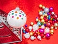 Christmas bauble on grater for vegetables grind on red glitter shiny background. Cooking or prepare Christmas, conceptual photo Royalty Free Stock Photo