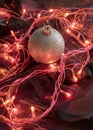 Christmas bauble ornament with holiday red pink lights around it.New Year night atmoshere decoration concept