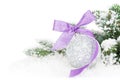 Christmas bauble and purple ribbon with snow fir tree Royalty Free Stock Photo