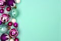 Christmas bauble side border on a turquoise background Royalty Free Stock Photo