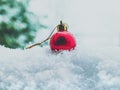 Christmas bauble in the snow, single red bauble