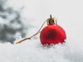 Christmas bauble in the snow, single red bauble