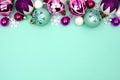 Christmas bauble top border on a turquoise background Royalty Free Stock Photo