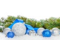 Christmas baubles and blue ribbon with snow fir tree Royalty Free Stock Photo