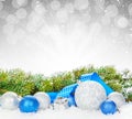 Christmas baubles and blue ribbon with snow fir tree Royalty Free Stock Photo