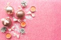 Christmas baubles with bows on pink glitter background. Royalty Free Stock Photo