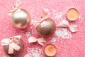 Christmas baubles with bows on pink glitter background. Royalty Free Stock Photo