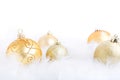 Christmas baubles on a feathery surface, brightly lit Royalty Free Stock Photo