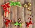 Christmas baubles, fir branches, gift, balls for the Christmas tree, candy canes, paper for text on a brown wooden table. Christma Royalty Free Stock Photo