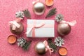 Christmas baubles and gift box on pink glitter background, copy space for the text. Royalty Free Stock Photo