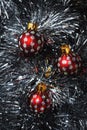 Christmas baubles nesting in silver tinsel