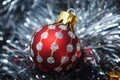 Christmas baubles nesting in silver tinsel