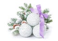 Christmas baubles and purple ribbon with snow fir tree Royalty Free Stock Photo