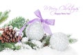 Christmas baubles and purple ribbon with snow fir tree Royalty Free Stock Photo