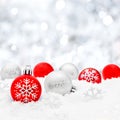 Christmas baubles in snow with silver background Royalty Free Stock Photo