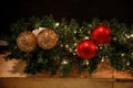Christmas baubles on wreath made of fir branches. Twigs pine, red and gold Christmas balls as decorations for New Year holidays. Royalty Free Stock Photo