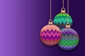 Christmas baubles with zigzag design against a purple background Royalty Free Stock Photo