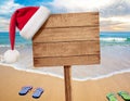 Christmas beach party signboard with two flip-flop pairs Royalty Free Stock Photo