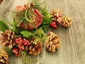 Christmas bell ball with pine and red ribbon,with pine cones and holly berries Royalty Free Stock Photo