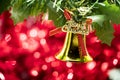 Christmas bell ornament hang on tree branch with red bokeh background Royalty Free Stock Photo