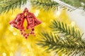 Christmas bell ornament hang on tree branch with yellow bokeh ba Royalty Free Stock Photo