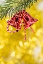 Christmas bell ornament hang on tree branch with yellow bokeh ba Royalty Free Stock Photo