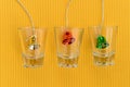 Christmas bells in glass on yellow background Royalty Free Stock Photo