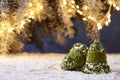 Christmas bells on snowy table on tree lights background Royalty Free Stock Photo