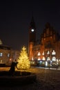 Sculpture Girl with ball in front of the lit Christmas tree in front of the Rathaus KÃÂ¶penick. Berlin, Germany