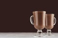 Christmas beverage - hot chocolate in mugs in elegant dark brown interior, copy space.