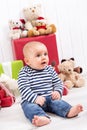 Christmas and birthday - cute baby sitting barefoot and looking Royalty Free Stock Photo